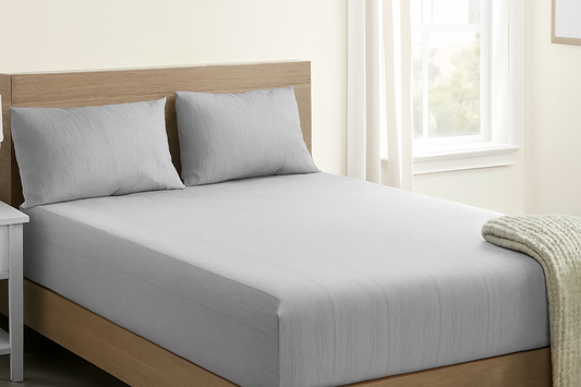 Bed with gray grounding sheet and pillowcases