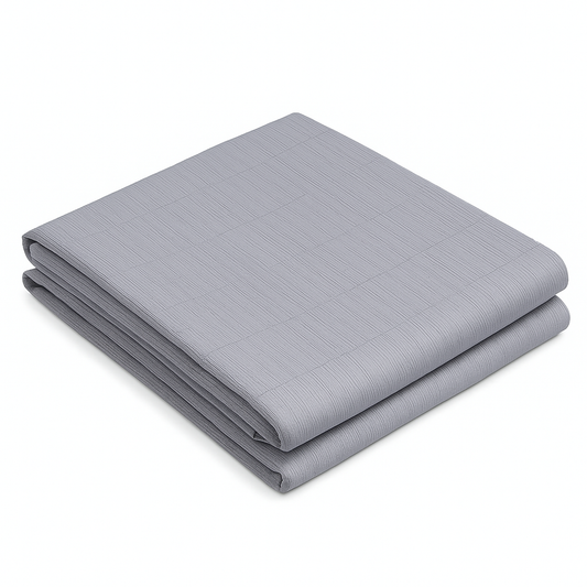 Folded gray grounding sheet made of soft organic cotton with a subtle grid-like textured pattern.