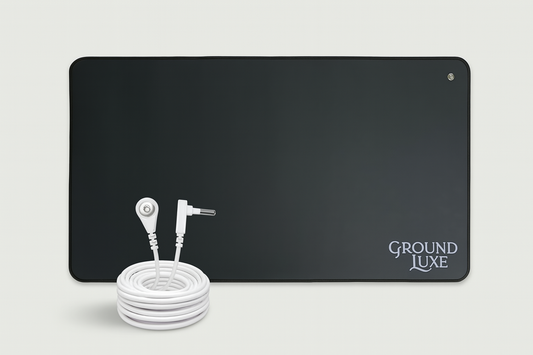GroundLuxe black grounding mat with white coiled cord on beige background, horizontal product view.
