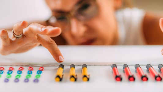 woman counting colored pens