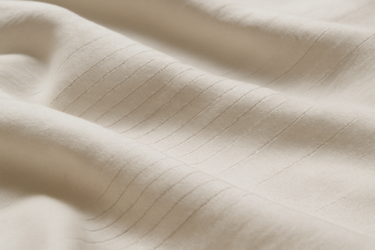 Close-up of organic cotton and silver fiber grounding sheet showcasing its intricate texture.