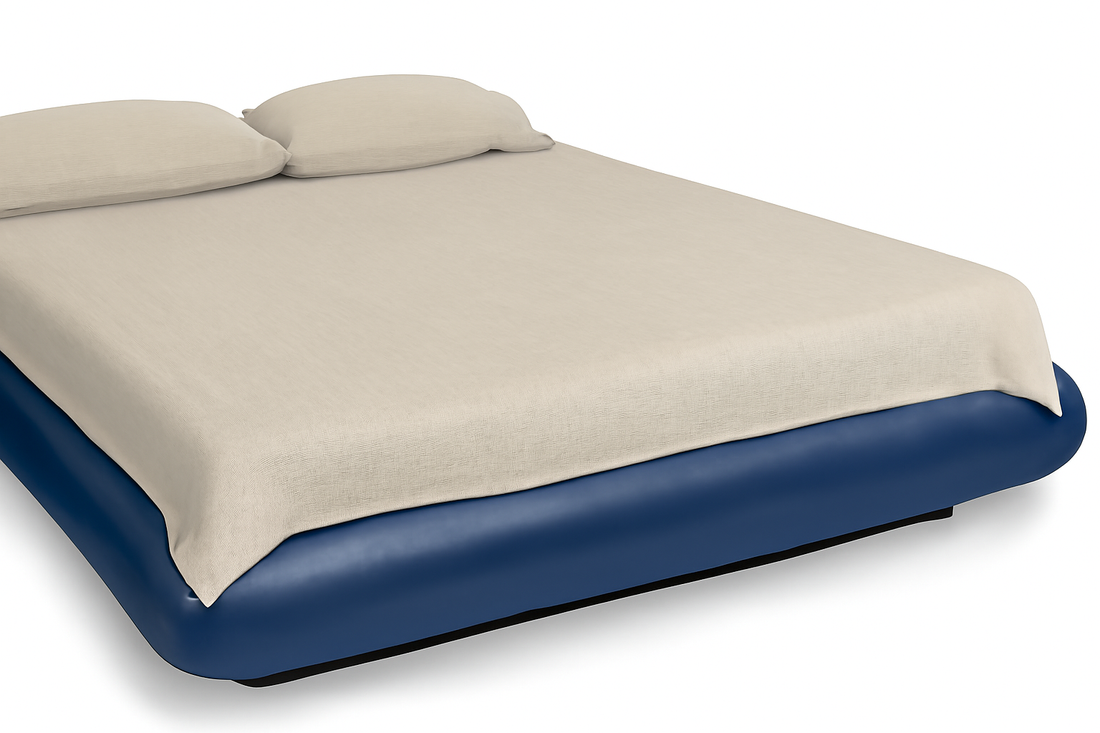 GroundLuxe fitted bed sheet on a navy blue waterbed, featuring a beige organic cotton sheet.