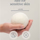 Hand holding a 3-inch wool dryer ball, non-toxic, fragrance-free.