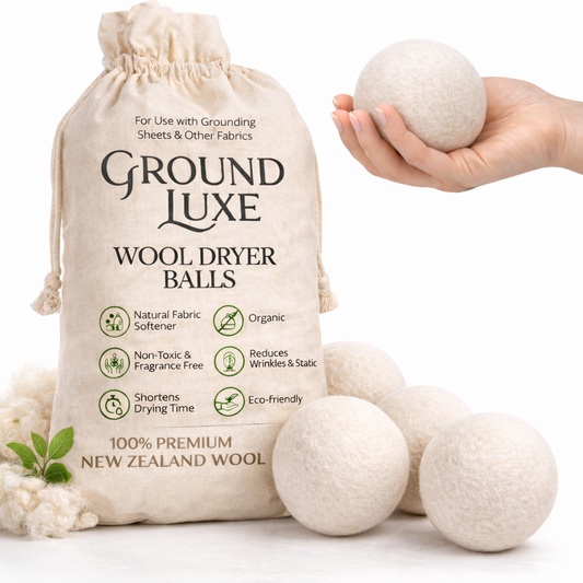 Ground Luxe wool dryer balls with packaging and a hand holding a ball on a white background

