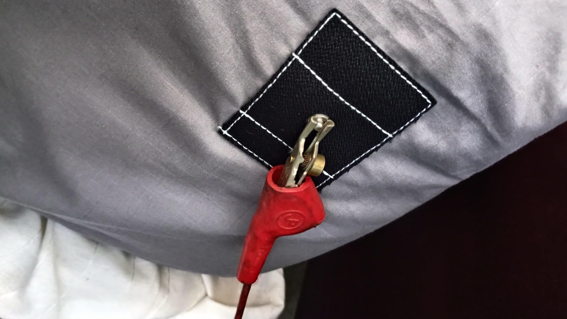 Grounding sheet with secure red clip connector used for menopause sleep support
