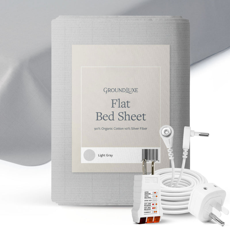 Flat Grounding Sheet in Light Gray. This folded organic cotton sheet is featured in its packaging and boasts 10% silver fiber from GroundLuxe.